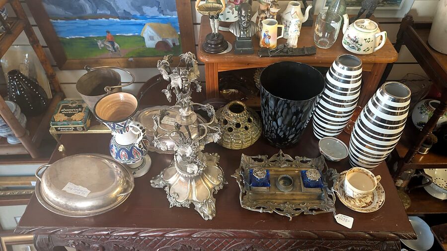 Silverware, teapots and glassware on display at Tom's Curios