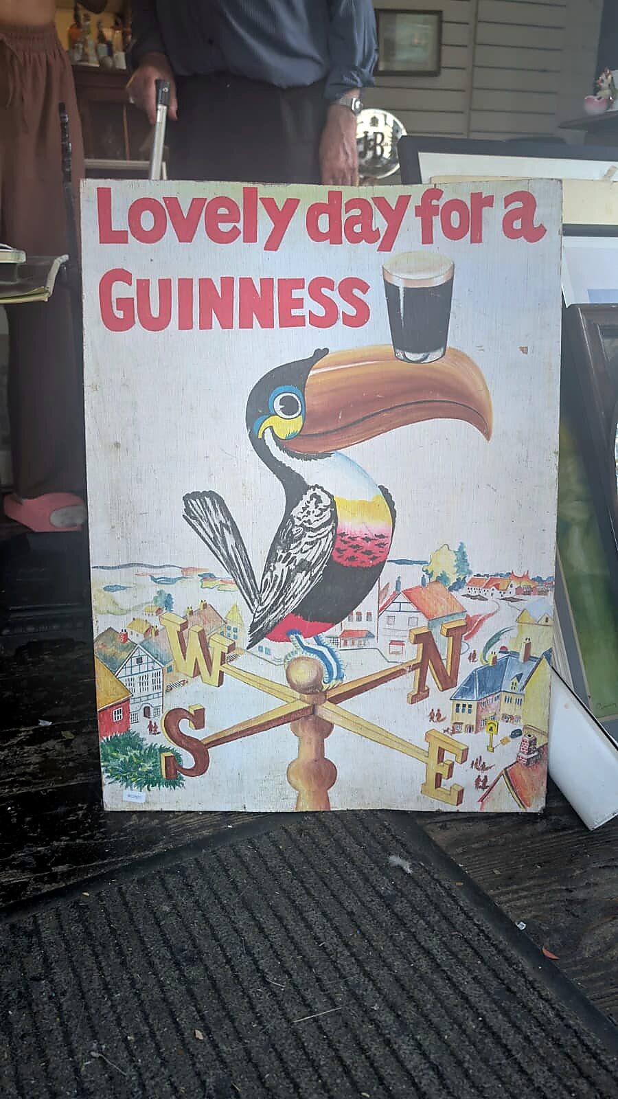 "Lovely day for a Guinness" painted pub sign at Tom's Curios